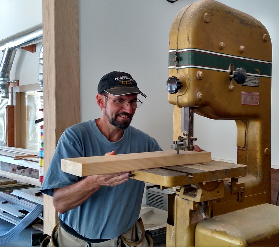 Riverport Youthboat Instructor Wayne Ford uses machinery to cut wood.